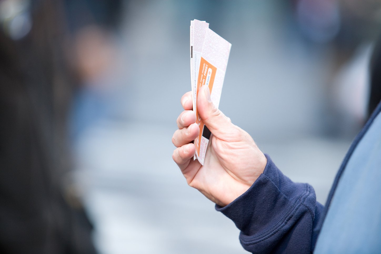 someone holding a pair of tickets